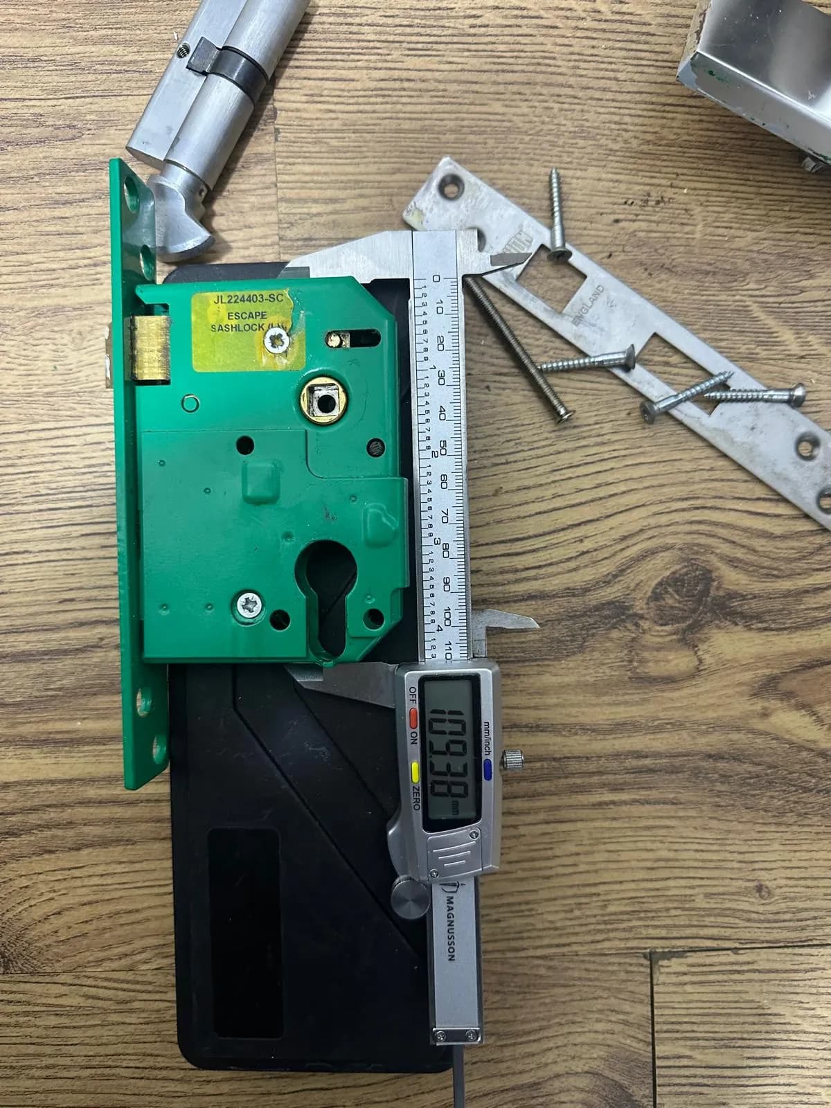 A sashlock case being measured with digital callipers.